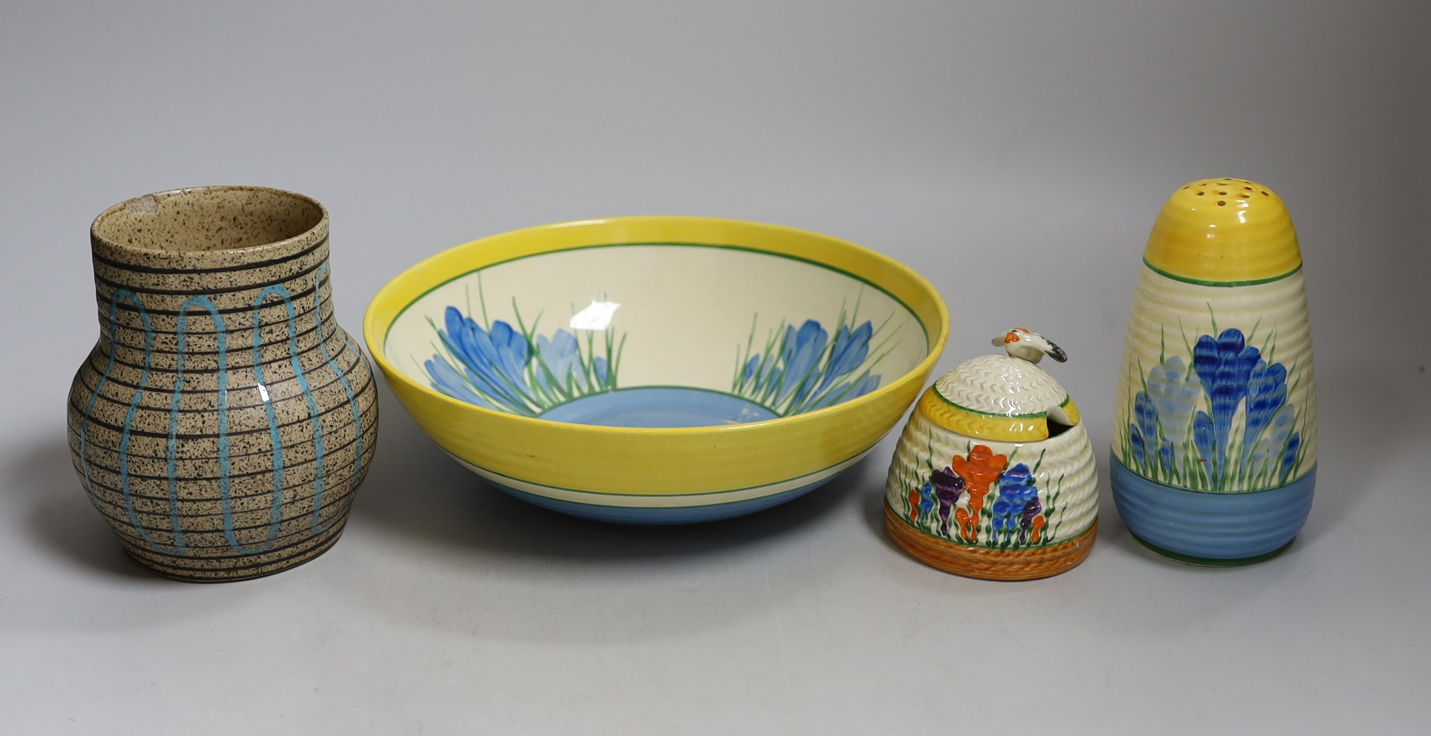 A Clarice Cliff blue crocus caster and bowl, a Clarice Cliff crocus honey pot and a late brown glazed vase. Tallest 18cm